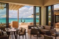 a restaurant with a view of the ocean at Rosewood Miyakojima in Miyako Island
