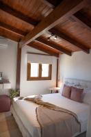 A bed or beds in a room at Michalis Apartment with Outdoor Jacuzzi