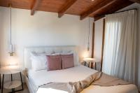 A bed or beds in a room at Michalis Apartment with Outdoor Jacuzzi
