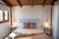 A bed or beds in a room at Michalis Apartment with Outdoor Jacuzzi