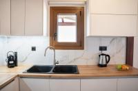 A kitchen or kitchenette at Michalis Apartment with Outdoor Jacuzzi