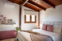 A bed or beds in a room at Michalis Apartment with Outdoor Jacuzzi