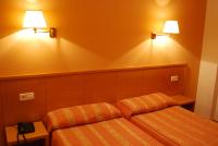 A bed or beds in a room at Hotel Santa Faz