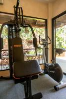 a gym with two exercise bikes and a simulator at Yaang Come Village Hotel in Chiang Mai