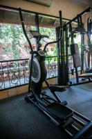 a gym with several treadmills and a treadmill at Yaang Come Village Hotel in Chiang Mai