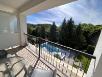 a balcony with a view of a swimming pool at Calimbra Wellness Hotel Superior in Miskolctapolca