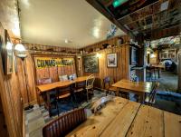 un ristorante con pareti e tavoli in legno e sedie di The Whod A Thought It a Glastonbury