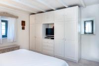 A bed or beds in a room at Authentic Cretan Stone Windmill
