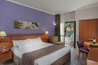 ein Hotelzimmer mit einem großen Bett und einem Schreibtisch in der Unterkunft Leonardo Privilege Eilat Hotel - All inclusive in Eilat