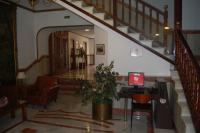 a lobby with a staircase with a computer on a desk at Hotel Marina Victoria in Algeciras