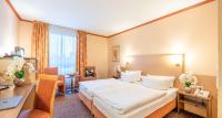 a hotel room with a bed and a desk at Sure Hotel by Best Western Hilden-Düsseldorf in Hilden