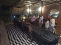 a group of people standing in a room with a table at Bar Ang Guesthouse in Battambang