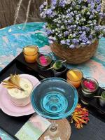 a table with a blue bowl and a basket of flowers at Xi You Hotel禧又 - near Xi'an City Wall, Daming Palace, with ticket service for featured scenic spots ,Paid Airport shuttle and tour charter services available,Complimentary Terracotta Warrior Souvenir and a cup of freshly ground coffee in Xi'an