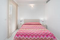 A bed or beds in a room at Cormorani - Appartamento 13