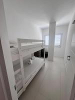 A bed or beds in a room at Cormorani - Appartamento 13