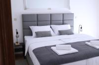 a large bed with two white towels on top of it at Artena Hotel in Pula