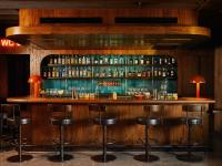 un bar con sgabelli di fronte a una parete in legno di Trailborn Grand Canyon, Outdoor Collection by Marriott Bonvoy a Williams