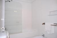 a white bathroom with a shower and a sink at Hotel Marina Victoria in Algeciras