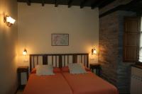 Postel nebo postele na pokoji v ubytování Apartamentos Rurales El Palacio de Doiras