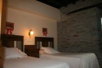 Postel nebo postele na pokoji v ubytování Apartamentos Rurales El Palacio de Doiras
