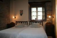 Postel nebo postele na pokoji v ubytování Apartamentos Rurales El Palacio de Doiras