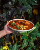 a person holding a plate with food on it at Hotel Casa Vertiz in Oaxaca City