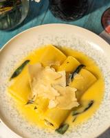 a white bowl of food with yellow food in it at Hotel Casa Vertiz in Oaxaca City