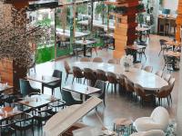 a restaurant with tables and chairs in a room at Canal Central Hotel Business Bay in Dubai