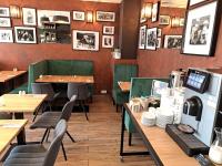 a restaurant with tables and chairs and pictures on the walls at Wilanów Residence Apartments in Warsaw