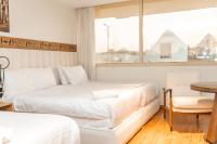 Postel nebo postele na pokoji v ubytování Superior Pyramids Inn