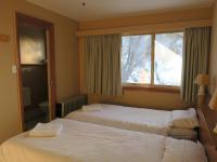 a hotel room with two beds and a window at Sundeck Hotel in Perisher Valley
