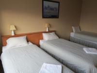 a hotel room with two beds and two lamps at Sundeck Hotel in Perisher Valley