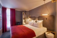 a bedroom with a large bed with a red blanket at Handsome Hotel in Paris