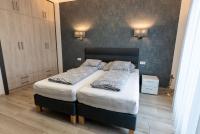 Postel nebo postele na pokoji v ubytování Jókai Apartman