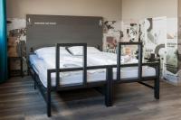 a bed with two shelves in a room at a&amp;o Graz Hauptbahnhof in Graz