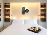 A bed or beds in a room at Sofitel Barcelona Skipper