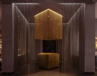 a lobby with a table and a glass wall at Salamander Washington DC in Washington