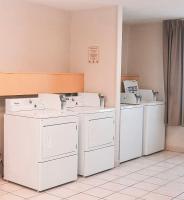 a room with white washers and dryers in a room at Quality Inn Airport in Colorado Springs