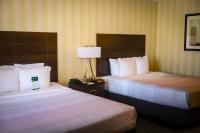 a hotel room with two beds and a lamp at Quality Inn Airport in Colorado Springs