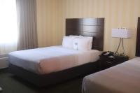 a hotel room with two beds and a lamp at Quality Inn Airport in Colorado Springs