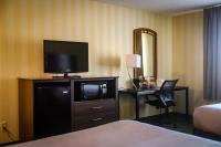 a hotel room with a television and a desk with a chair at Quality Inn Airport in Colorado Springs