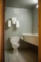 a bathroom with a toilet and a sink and a tub at Quality Inn Airport in Colorado Springs