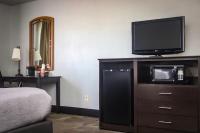 a bedroom with a tv and a dresser with a microwave at Quality Inn Airport in Colorado Springs