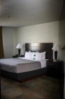 a hotel room with a large bed with two lamps at Quality Inn Airport in Colorado Springs
