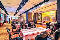 a dining room with tables and chairs and a restaurant at Uiles Hotel in Hohhot