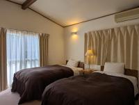 En eller flere senge i et værelse på Kawaguchiko Hotel