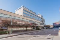 an empty street in front of a large building at Hotel Slovakia in Žilina