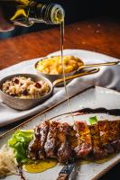 un piatto di carne con salsa che viene versato sopra di House Marica a Šmartno (San Martino)