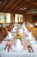 a long table with glasses and napkins on it at Alpengasthaus Gießlhütte in Wolfsberg