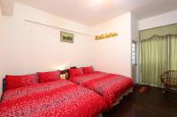 a bedroom with two red beds and a window at Fangyi Homestay in Ji&#39;an